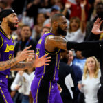 MINNEAPOLIS, MINNESOTA - DECEMBER 30: LeBron James #23 (C) and Anthony Davis #3 of the Los Angeles Lakers react as it's announced James' basket is upheld as a two-point basket after review against the Minnesota Timberwolves in the fourth quarter at Target Center on December 30, 2023 in Minneapolis, Minnesota. The Timberwolves defeated the Lakers 108-106