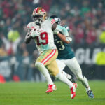 PHILADELPHIA, PENNSYLVANIA - DECEMBER 3: Deebo Samuel #19 of the San Francisco 49ers runs past Christian Elliss #53 of the Philadelphia Eagles at Lincoln Financial Field on December 3, 2023 in Philadelphia, Pennsylvania.