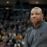 MILWAUKEE, WISCONSIN - JANUARY 27: Head coach Doc Rivers of the Milwaukee Bucks speaks to the crowd in the first half of the game between the Seton Hall Pirates and Marquette Golden Eagles at Fiserv Forum on January 27, 2024 in Milwaukee, Wisconsin