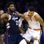 PHILADELPHIA, PENNSYLVANIA - JANUARY 22: Joel Embiid #21 of the Philadelphia 76ers and Victor Wembanyama #1 of the San Antonio Spurs jostle during the first quarter at the Wells Fargo Center on January 22, 2024 in Philadelphia, Pennsylvania.