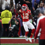 LAS VEGAS, NEVADA - FEBRUARY 11: Mecole Hardman Jr. #12 of the Kansas City Chiefs catches a pass for a touchdown to defeat the San Francisco 49ers 25-22 in overtime during Super Bowl LVIII at Allegiant Stadium on February 11, 2024 in Las Vegas, Nevada.