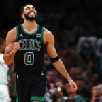 BOSTON, MASSACHUSETTS - NOVEMBER 22: Jayson Tatum #0 of the Boston Celtics reacts after Jrue Holiday #4 missed a shot against the Milwaukee Bucks during the second quarter at TD Garden on November 22, 2023 in Boston, Massachusetts.