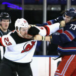 NEW YORK, NEW YORK - APRIL 03: Kurtis MacDermid #23 of the New Jersey Devils fights with Matt Rempe #73 of the New York Rangers during the first period at Madison Square Garden on April 03, 2024 in New York City