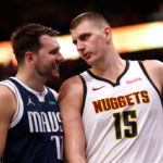 DALLAS, TX - MARCH 17: Luka Doncic #77 of the Dallas Mavericks and Nikola Jokic #15 of the Denver Nuggets talk during a beak in the action in the second half at American Airlines Center on March 17, 2024 in Dallas, Texas.