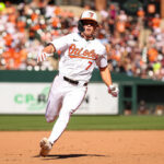 BALTIMORE, MD - APRIL 14: Jackson Holliday #7 of the Baltimore Orioles advances to third base during the seventh inning against the Milwaukee Brewers at Oriole Park at Camden Yards on April 14, 2024 in Baltimore, Maryland.