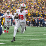 ANN ARBOR, MICHIGAN - NOVEMBER 25: Marvin Harrison Jr. #18 of the Ohio State Buckeyes runs with the ball for a touchdown during the second half of a college football game against the Michigan Wolverines at Michigan Stadium on November 25, 2023 in Ann Arbor, Michigan. The Michigan Wolverines won the game 30-24 to win the Big Ten East.