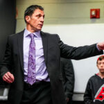 RALEIGH, NORTH CAROLINA - MARCH 21: Carolina Hurricanes head coach Rod Brind'Amour talks in the locker room after an NHL hockey game against the Philadelphia Flyers at PNC Arena on March 21, 2024 in Raleigh, North Carolina.