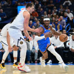 OKLAHOMA CITY, OKLAHOMA - OCTOBER 29: Shai Gilgeous-Alexander #2 of the Oklahoma City Thunder attempts to drive past Nikola Jokic #15 of the Denver Nuggets during the first quarter of a game at Paycom Center on October 29, 2023 in Oklahoma City, Oklahoma.