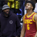 BERKELEY, CALIFORNIA - FEBRUARY 07: LeBron James #23 of the Los Angeles Lakers shouts to his son, Bronny James #6 of the USC Trojans, during Bronny's game against the California Golden Bears at Haas Pavilion on February 07, 2024 in Berkeley, California.