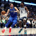 DALLAS, TEXAS - DECEMBER 14: Luka Doncic #77 of the Dallas Mavericks drives to the basket against Anthony Edwards #5 of the Minnesota Timberwolves in the second half at American Airlines Center on December 14, 2023 in Dallas, Texas. NOTE TO USER: User expressly acknowledges and agrees that, by downloading and or using this photograph, User is consenting to the terms and conditions of the Getty Images License Agreement.
