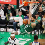BOSTON, MASSACHUSETTS - JUNE 17: Jayson Tatum #0 of the Boston Celtics reacts after a dunk during the third quarter of Game Five of the 2024 NBA Finals against the Dallas Mavericks at TD Garden on June 17, 2024 in Boston, Massachusetts.