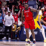 Apr 16, 2024; New Orleans, Louisiana, USA; New Orleans Pelicans forward Zion Williamson (1) reacts to making a basket against Los Angeles Lakers forward Anthony Davis (3) during the second half of a play-in game of the 2024 NBA playoffs at Smoothie King Center.