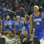 Apr 21, 2024; Los Angeles, California, USA; Los Angeles Clippers guard Terance Mann (14) heads down court after a 3-point basket in the second half of game one of the first round for the 2024 NBA playoffs against the Dallas Mavericks at Crypto.com Arena.