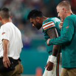 Sep 12, 2024; Miami Gardens, Florida, USA; Miami Dolphins quarterback Tua Tagovailoa (1) walks off the field with training staff after an apparent injury during the second half against the Buffalo Bills at Hard Rock Stadium. Mandatory Credit: Jasen Vinlove-Imagn Images