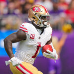 Sep 15, 2024; Minneapolis, Minnesota, USA; San Francisco 49ers wide receiver Deebo Samuel Sr. (1) runs back a kick against the Minnesota Vikings in the first quarter at U.S. Bank Stadium.