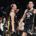Sep 24, 2024; Brooklyn, New York, USA; New York Liberty guard Sabrina Ionescu (20) celebrates with forward Breanna Stewart (30) during game two of the first round of the 2024 WNBA Playoffs against the Atlanta Dream at Barclays Center.
