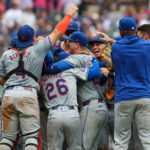 Sep 30, 2024; Atlanta, Georgia, USA; New York Mets catcher Francisco Alvarez (4) and second baseman Eddy Alvarez (26) and first baseman Pete Alonso (20) celebrate after a victory over the Atlanta Braves that clinched a wild card playoff birth at Truist Park