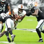 Sep 29, 2024; Paradise, Nevada, USA; Cleveland Browns quarterback Deshaun Watson (4) braces for the tackles of Las Vegas Raiders safety Isaiah Pola-Mao (20) and Las Vegas Raiders linebacker Amari Burney (56) during the first quarter at Allegiant Stadium.