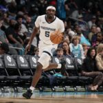 Feb 10, 2024; Charlotte, North Carolina, USA; Memphis Grizzlies guard Vince Williams Jr. (5) brings the ball up court against the Charlotte Hornets during the second half at Spectrum Center.