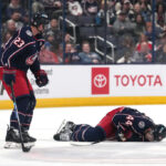COLUMBUS, OHIO - OCTOBER 15: Erik Gudbranson #44 of the Columbus Blue Jackets lies on the ice after colliding with teammate Sean Monahan #23 during the second period against the Florida Panthers at Nationwide Arena on October 15, 2024 in Columbus, Ohio.