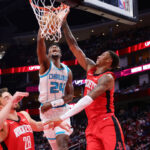 HOUSTON, TEXAS - OCTOBER 23: Brandon Miller #24 of the Charlotte Hornets slam dunks the ball over Alperen Sengun #28 of the Houston Rockets and Jabari Smith Jr. #10 during the first half at Toyota Center on October 23, 2024 in Houston, Texas. NOTE TO USER: User expressly acknowledges and agrees that, by downloading and or using this photograph, User is consenting to the terms and conditions of the Getty Images License Agreement. (Photo by Alex Slitz/Getty Images)
