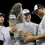 NEW YORK - NOVEMBER 04: (L-R) Andy Pettitte #46, Jorge Posada #20, Derek Jeter #2 and Mariano Rivera #42 of the New York Yankees celebrate with the trophy after their 7-3 win against the Philadelphia Phillies in Game Six of the 2009 MLB World Series at Yankee Stadium on November 4, 2009 in the Bronx borough of New York City. (Photo by Pool/Getty Images)