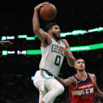 Oct 27, 2021; Boston, Massachusetts, USA; Boston Celtics forward Jayson Tatum (0) goes to the basket past Washington Wizards forward Kyle Kuzma (33) during the second half at TD Garden.