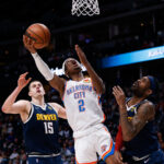 Mar 2, 2022; Denver, Colorado, USA; Oklahoma City Thunder guard Shai Gilgeous-Alexander (2) drives to the net against Denver Nuggets forward Will Barton (5) and center Nikola Jokic (15) in the fourth quarter at Ball Arena.