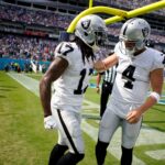 Las Vegas Raiders wide receiver Davante Adams (17) celebrates his touch down with quarterback Derek Carr (4) during the second quarter at Nissan Stadium Sunday, Sept. 25, 2022, in Nashville, Tenn.