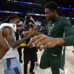Dec 15, 2022; Memphis, Tennessee, USA; Memphis Grizzlies guard Ja Morant (left) and Milwaukee Bucks forward Giannis Antetokounmpo (34) shake hands after the game at FedExForum.