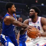Jan 17, 2023; Los Angeles, California, USA; Philadelphia 76ers center Joel Embiid (21) is fouled by LA Clippers guard Paul George (13) in the first half at Crypto.com Arena. Mandatory Credit: Kirby Lee-USA TODAY Sports
