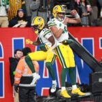 Dec 11, 2023; East Rutherford, New Jersey, USA; Green Bay Packers wide receiver Jayden Reed (11) and Green Bay Packers quarterback Jordan Love (10) celebrate after a touchdown during the second quarter against the New York Giants at MetLife Stadium. Mandatory Credit: Vincent Carchietta-USA TODAY Sports