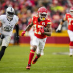 Dec 25, 2023; Kansas City, Missouri, USA; NFL; Kansas City Chiefs wide receiver Richie James (17) runs with the ball past Las Vegas Raiders linebacker Robert Spillane (41) during the second half at GEHA Field at Arrowhead Stadium.
