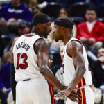 Dec 31, 2022; Salt Lake City, Utah, USA; Miami Heat forward Jimmy Butler (22) and center/forward Bam Adebayo (13) talk before a free-throw shot against the Utah Jazz during the second half at Vivint Arena.