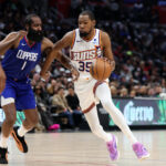 Jan 8, 2024; Los Angeles, California, USA; NBA; Phoenix Suns forward Kevin Durant (35) dribbles the ball against Los Angeles Clippers guard James Harden (1) during the fourth quarter at Crypto.com Arena.