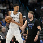 Feb 14, 2024; Dallas, Texas, USA; NBA; San Antonio Spurs center Victor Wembanyama (1) looks to move the ball past Dallas Mavericks guard Luka Doncic (77) during the fist quarter at the American Airlines Center.