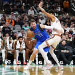 Mar 19, 2024; San Antonio, Texas, USA; NBA; Dallas Mavericks guard Luka Doncic (77) dribbles against San Antonio Spurs center Victor Wembanyama (1) in the second half at Frost Bank Center.