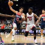 Mar 31, 2024; Washington, District of Columbia, USA; Washington Wizards guard Jordan Poole (13) drives to the basket against Miami Heat forward Jimmy Butler (22) during the third quarter at Capital One Arena.