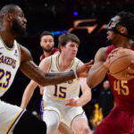 Apr 6, 2024; Los Angeles, California, USA; NBA; Cleveland Cavaliers guard Donovan Mitchell (45) controls the ball against Los Angeles Lakers forward LeBron James (23) during the first half at Crypto.com Arena.