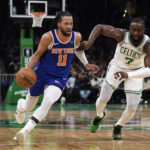 Apr 11, 2024; Boston, Massachusetts, USA; New York Knicks guard Jalen Brunson (11) controls the ball while Boston Celtics guard Jaylen Brown (7) defends during the first half at TD Garden.