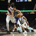 Apr 11, 2024; Portland, Oregon, USA; Golden State Warriors guard Stephen Curry (30) drives to the basket during the first half against Portland Trail Blazers center Deandre Ayton (2) at Moda Center.