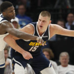 May 12, 2024; Minneapolis, Minnesota, USA; NBA; Denver Nuggets center Nikola Jokic (15) works around Minnesota Timberwolves guard Anthony Edwards (5) in the fourth quarter of game four of the second round for the 2024 NBA playoffs at Target Center.