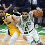 May 21, 2024; Boston, Massachusetts, USA; Boston Celtics forward Jayson Tatum (0) drives the ball against Indiana Pacers guard Tyrese Haliburton (0) in over-time during game one of the eastern conference finals for the 2024 NBA playoffs at TD Garden.