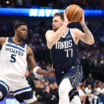 May 28, 2024; Dallas, Texas, USA; Dallas Mavericks guard Luka Doncic (77) dribbles against Minnesota Timberwolves guard Anthony Edwards (5) during the third quarter of game four of the western conference finals for the 2024 NBA playoffs at American Airlines Center.