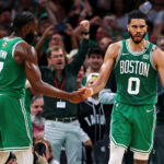 Jun 17, 2024; Boston, Massachusetts, USA; NBA; Boston Celtics forward Jayson Tatum (0) celebrates with guard Jaylen Brown (7) after a play against the Dallas Mavericks in game five of the 2024 NBA Finals at TD Garden.