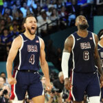 Aug 10, 2024; Paris, France; United States shooting guard Stephen Curry (4) and guard LeBron James (6) react in the second half against France in the men's basketball gold medal game during the Paris 2024 Olympic Summer Games at Accor Arena.