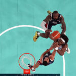 Aug 10, 2024; Paris, France; France power forward Guerschon Yabusele (7) shoots against United States guard LeBron James (6) and shooting guard Stephen Curry (4) in the second half in the men's basketball gold medal game during the Paris 2024 Olympic Summer Games at Accor Arena.