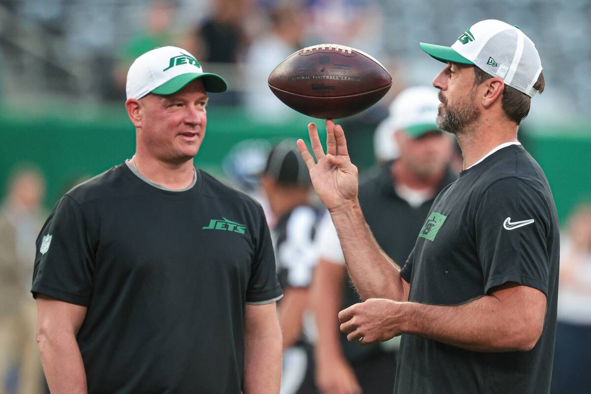 Aug 24, 2024; East Rutherford, New Jersey, USA; New York Jets quarterback Aaron Rodgers (left) spins the ball in front of offensive coordinator Nathaniel Hackett before the game against the New York Giants at MetLife Stadium. Mandatory Credit: Vincent Carchietta-USA TODAY Sports