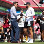 Sep 29, 2024; Tampa, Florida, USA; Fox NFL broadcaster and former NFL quarterback Tom Brady speaks to Tampa Bay Buccaneers quarterback Baker Mayfield (6) before a game against the Philadelphia Eagles at Raymond James Stadium. Mandatory Credit: Nathan Ray Seebeck-Imagn Images