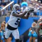 Sep 29, 2024; Charlotte, North Carolina, USA; Carolina Panthers wide receiver Diontae Johnson (5) catches a pass from quarterback Andy Dalton (14) for a touchdown during the third quarter at Bank of America Stadium. Mandatory Credit: Jim Dedmon-Imagn Images
